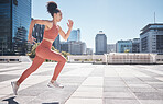 Fitness, city and woman running for exercise, health and wellness. Sports runner, energy and female athlete exercising, cardio or training workout outdoors on street for race, marathon or endurance.