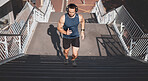 Urban fitness, man running on stairs and listening to music on headphones on outdoor exercise in Los Angeles. Health, motivation and a California city runner on steps for marathon training in morning