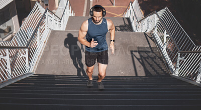 Buy stock photo Urban fitness, man running on stairs and listening to music on headphones on outdoor exercise in Los Angeles. Health, motivation and a California city runner on steps for marathon training in morning