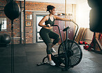 Fitness, exercise bike and woman at gym for workout, cardio training and cycling for energy, balance and lose weight. Sports female or athlete with spinning machine for health, wellness and self care