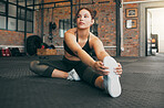 Fitness woman, exercise and stretching at gym for warm up workout and training for health, balance and wellness. Sports female or athlete on floor to stretch body or legs to be flexible and healthy