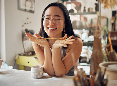 Buy stock photo Portrait, pottery and art with an asian woman in her studio or workshop for design and creative hobby. Happy, smile or designer with a female artist working in her small business startup for ceramics