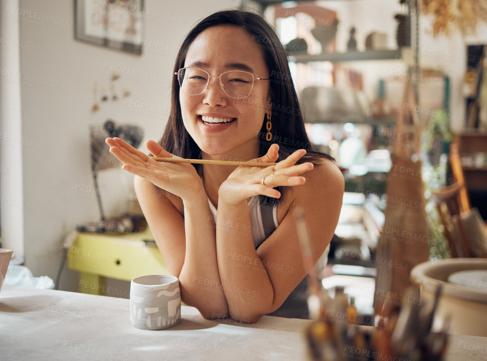 Buy stock photo Portrait, pottery and art with an asian woman in her studio or workshop for design and creative hobby. Happy, smile or designer with a female artist working in her small business startup for ceramics