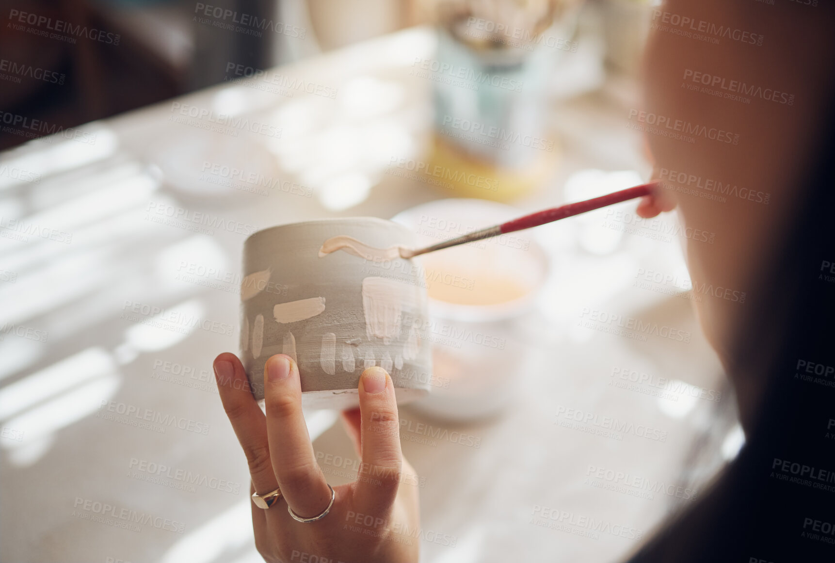 Buy stock photo Woman hands, pottery studio and painting cup in workshop for sculpture, creative manufacturing or design. Painter, ceramics product and brush process, artistic pattern or production in small business