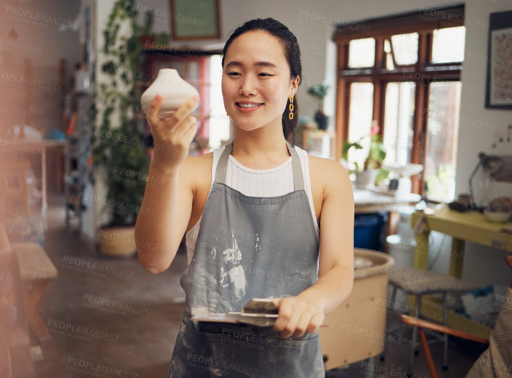 Buy stock photo Creative, art and woman in workshop with clay pot, ceramics and pottery with creativity and pride in work. Happy artist with texture, sculpting and creation in hand with clipboard for product check