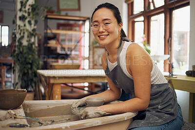 Buy stock photo Pottery, startup business and creative woman portrait in her workshop for art with hands in mud. Asian artist with potter wheel for clay or ceramic retail industry, trade or production with pride