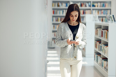 Buy stock photo Phone, library and woman networking on social media, mobile app or the internet with mobile. Books, knowledge and young female student typing or reading a text message on her cellphone at university.