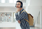 Thinking, headphones and library student at university, college or academy idea for research, learning and knowledge. Study, education and creative, geek man listening to audio for school inspiration