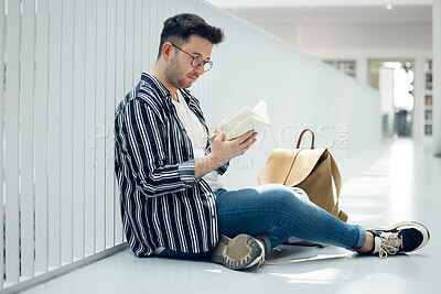 Buy stock photo Man, student and reading with glasses and book for knowledge, education or learning at university. Male learner in library with books for thesis, project or assignment for scholarship at the campus