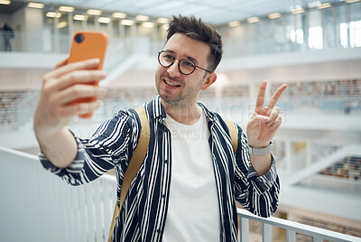 Buy stock photo College student, man and library selfie at campus with phone, peace hand and smile on social media. Gen z, university student and smartphone app for social network, happiness and studying for success