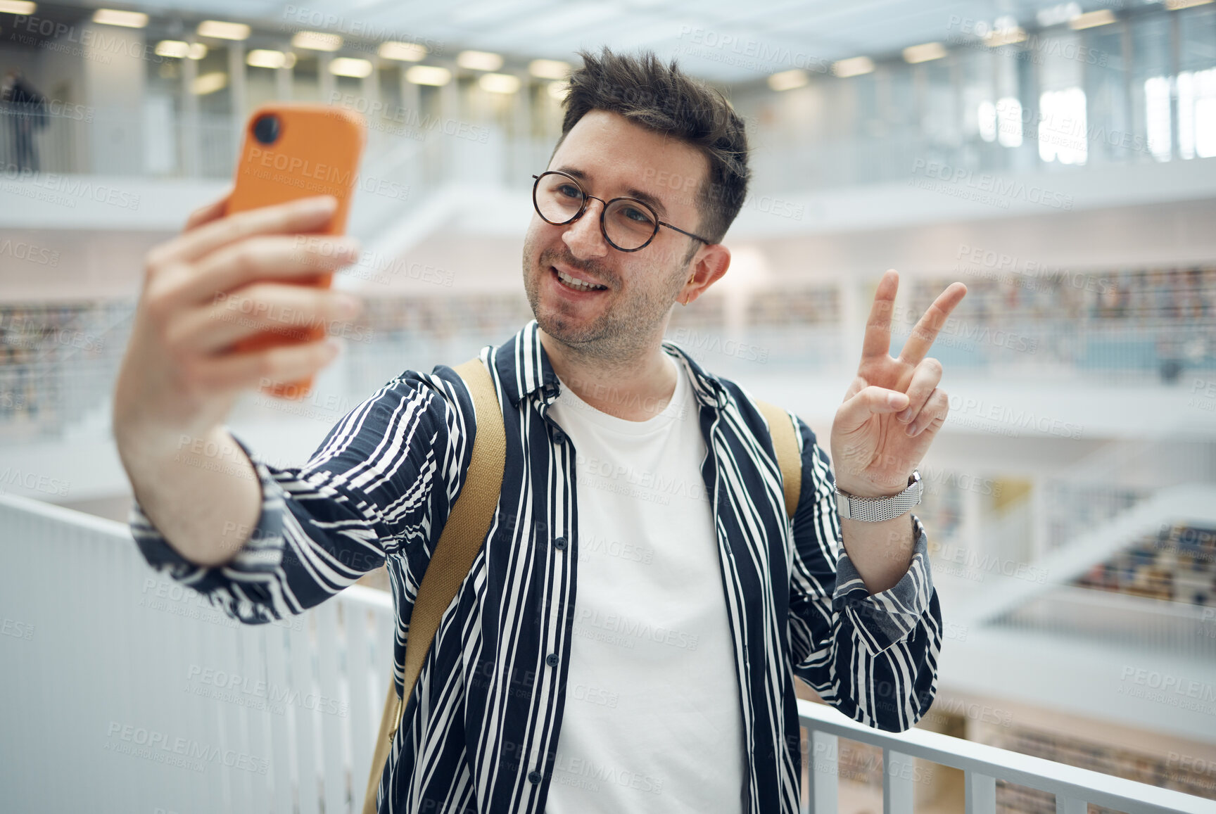 Buy stock photo College student, man and library selfie at campus with phone, peace hand and smile on social media. Gen z, university student and smartphone app for social network, happiness and studying for success
