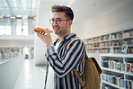 Man, phone call and speaker in library, smile and connection for communication, talking and planning study date. Young male, student or academic with smartphone, speaking or conversation in bookstore