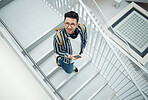 Happy or startup man with phone on staircase for internet research, social media content or networking. Smile or employee looking up on smartphone for social network, blog review or communication