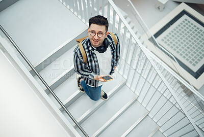 Buy stock photo Happy, student or startup man with phone on staircase for internet research, social media content or networking. Smile, top or employee nerd on smartphone for strategy, blog review or communication