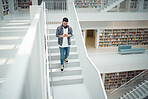 College student, walking stairs and campus with phone, reading and communication on social media. Man, university student and smartphone app for email in library for education, learning and studying