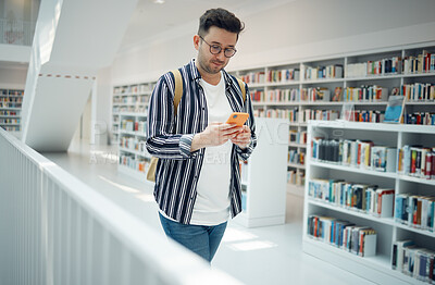 Buy stock photo Education, social media and man with a phone in a library for communication, wifi connection and online chat at college. University, learning and student with a mobile for research and typing email