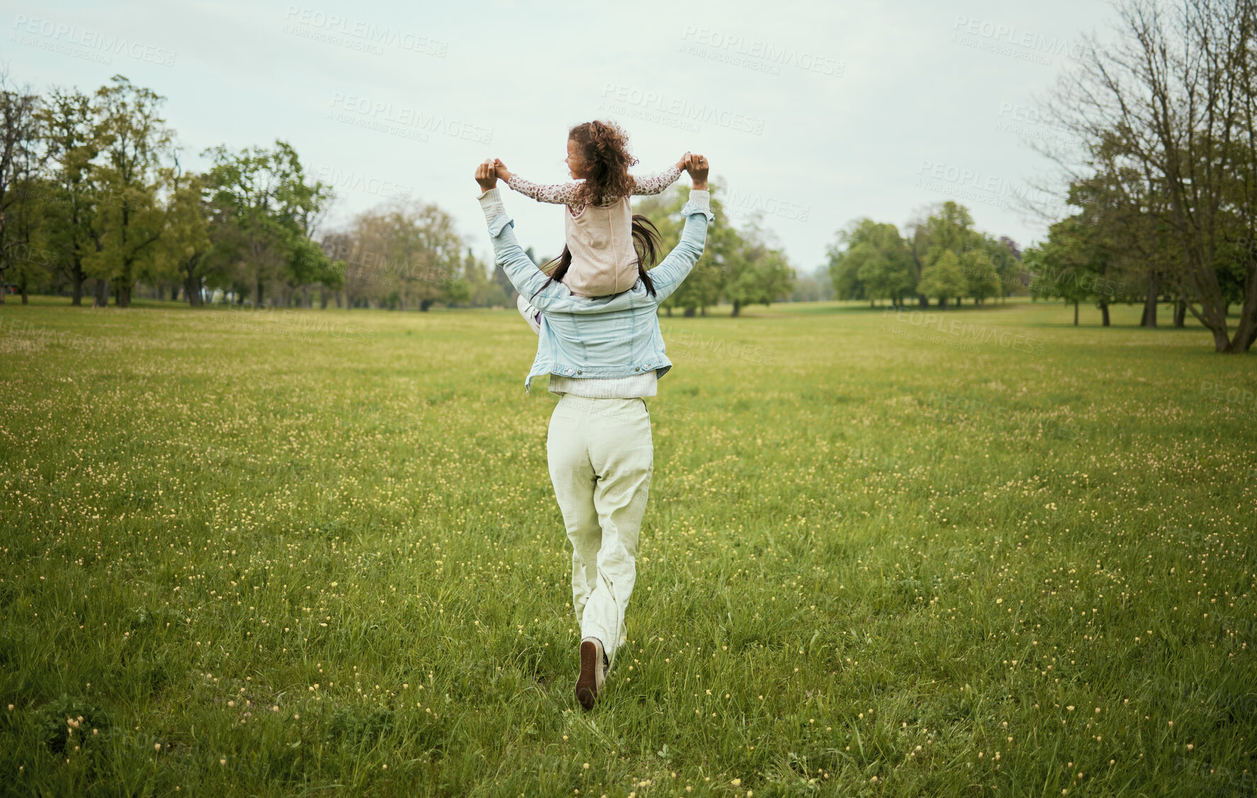 Buy stock photo Mother, child and piggyback in the nature countryside for bonding relationship, freedom or weekend travel. Mom holding daughter on back playing together for fun in the park on the open green field