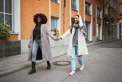 Buy stock photo Fashion, holding hands and lesbian couple walking in street enjoying holiday, vacation and adventure on weekend. Love, lgbtq relationship and women together for happy lifestyle, freedom and relaxing