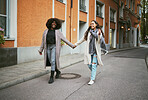 Love, holding hands and lesbian couple walking in street enjoying holiday, vacation and adventure on weekend. Fashion, lgbtq relationship and women together for happy lifestyle, freedom and relaxing