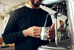 Hands, barista and brewing coffee in kitchen using machine for hot beverage, caffeine or steam. Hand of employee male steaming milk in metal jug for premium grade drink or self service at cafe