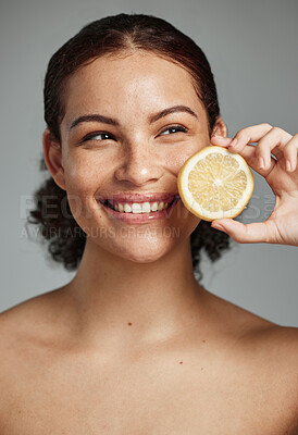 Buy stock photo Skincare, face and woman with lemon in studio isolated on a gray background. Fruit, organic cosmetics and happy female model holding fruits for healthy diet, vitamin c or minerals, wellness or beauty