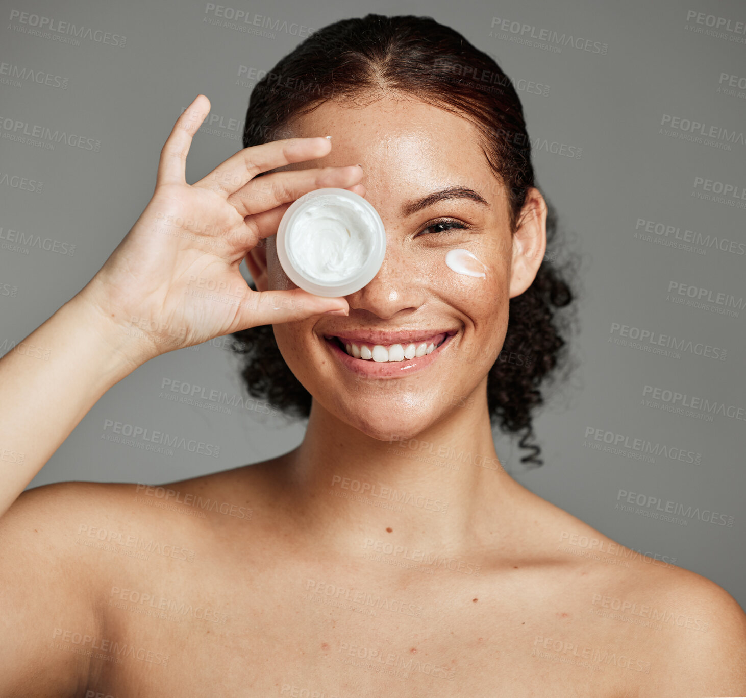 Buy stock photo Black woman, smile portrait and cream for beauty wellness shine, eyes cosmetic dermatology and spa product in grey studio. Happy African girl, facial moisturizer and spf sunscreen or luxury skin glow