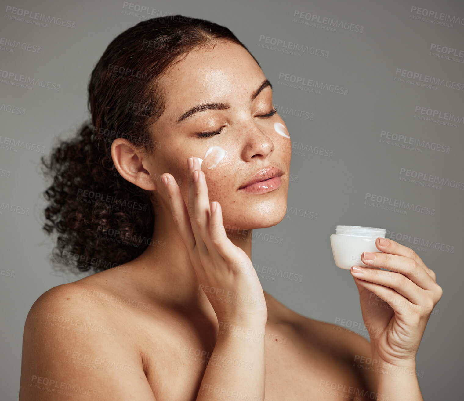 Buy stock photo Black woman, face and skincare cream for beauty wellness shine, cosmetics dermatology and salon spa product in studio. African girl hands, facial moisturizer and spf sunscreen or luxury makeup glow