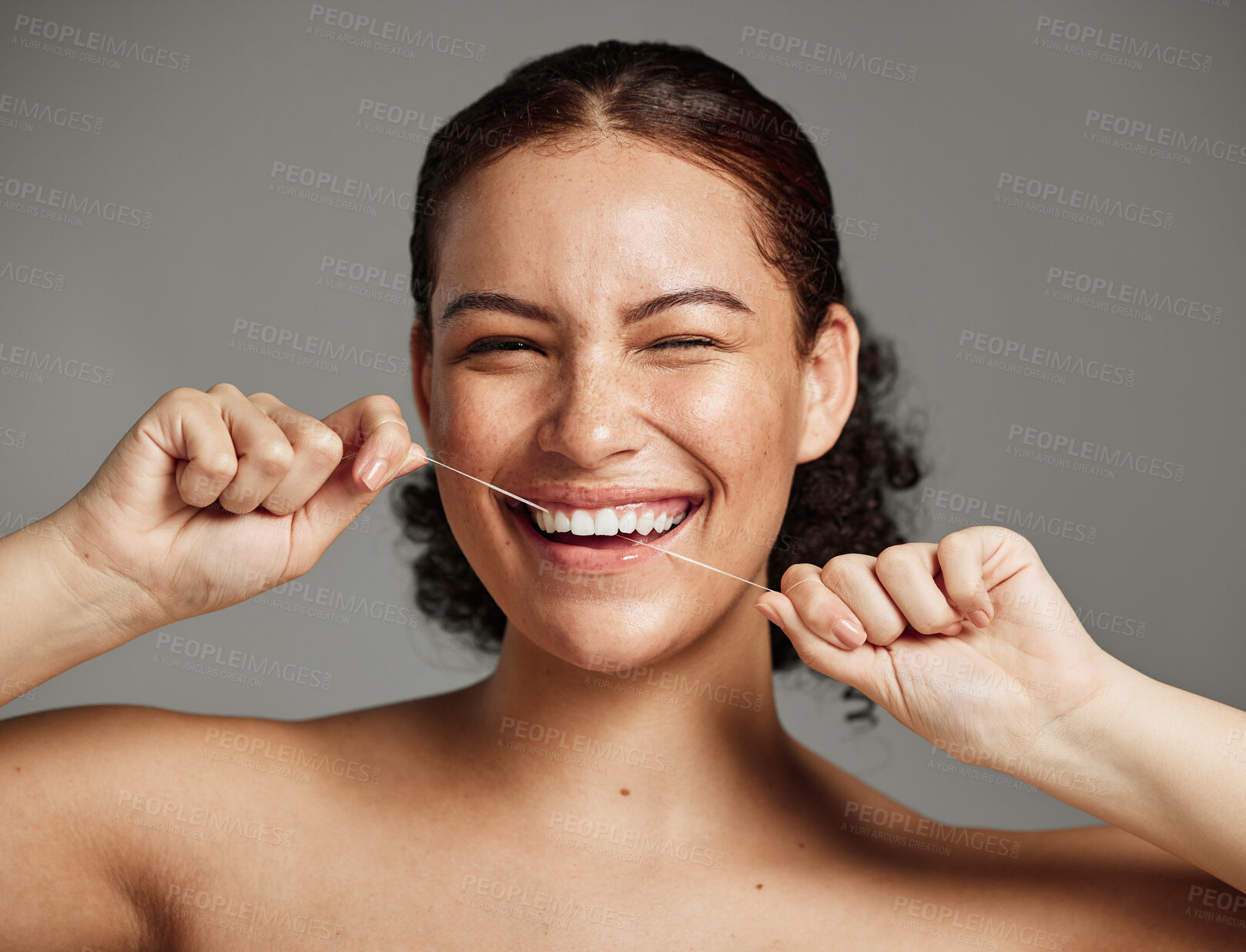 Buy stock photo Dental floss, flossing teeth and woman with a smile for oral hygiene, health and wellness on studio background. Face of a happy female during self care, healthcare and grooming for a healthy mouth