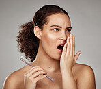 Toothbrush, woman and bad breath with dental problem while smelling odor of mouth, teeth or gums in hand. Face of a female in studio for oral health, brushing teeth and self care on grey background