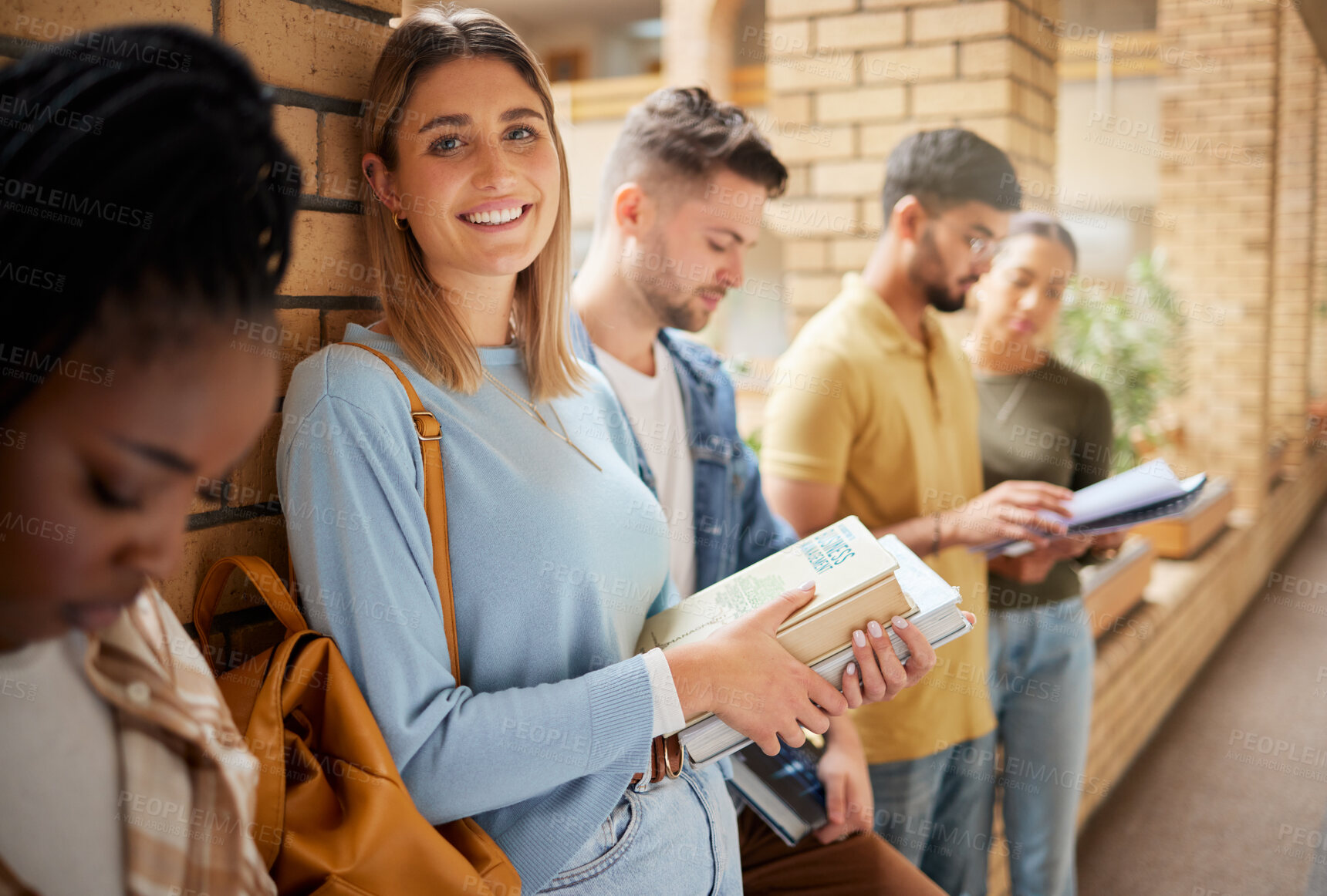 Buy stock photo University, lobby and portrait of woman and students standing in row together with books at business school. Friends, education and future, girl from USA in study group on campus in corridor for exam