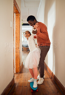 Buy stock photo Learning, skateboard and fun with father and daughter in their house, happy and smile while holding for balance. Skating, playing and girl with parent on a board, laughing and teaching in their home