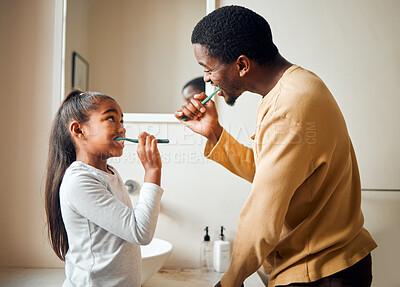 Buy stock photo Brushing teeth, bonding and father with daughter in a bathroom for hygiene and dental grooming. Oral, care and girl with parent, teeth and cleaning with black family, playful and learning at home