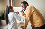Oral care, brushing teeth and father with daughter in bathroom for hygiene, grooming and bonding. Dental health, girl and parent, teeth and cleaning while having fun, playful and smile in their home