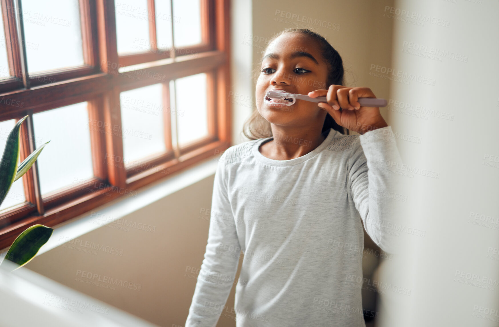 Buy stock photo Girl brushing teeth, dental and toothbrush for hygiene with clean mouth and fresh breath with oral health. Kid, cleaning with toothpaste in bathroom and wellness at family home with healthy gums