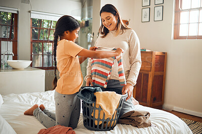 Buy stock photo Laundry, pregnant mother and child help with house chores and cleaning with love and care. Folding clothes, happy and working family in a bedroom bed busy with clean clothing fold in a house 