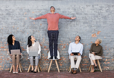 Buy stock photo Business people, waiting room and man standing out for interview, meeting or opportunity against a brick wall. Group of employee workers or interns with technology looking at candidate on chair
