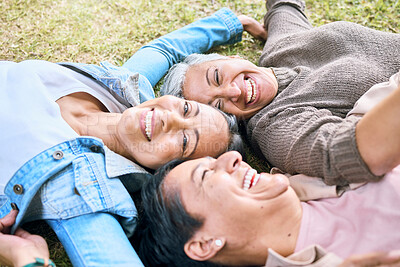 Buy stock photo Elderly, happy or friends on grass in a park talking or speaking of funny gossip relaxing holiday vacation in summer. Smile, old people or senior women laughing at a crazy joke or bonding in nature