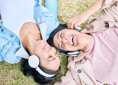 Buy stock photo Face, friends and happy with women and headphones, listening to music outdoor with podcast and technology. Happiness top view, radio and audio streaming in park with people together and wellness