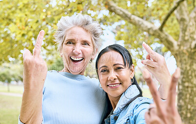 Buy stock photo Senior women, park portrait and hand sign for comic, funny and happy time together in nature. Old woman, friends and hands with peace, middle finger and laughing by trees, nature or forest to relax