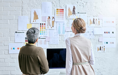 Buy stock photo Fashion, designer teamwork and back of women in workshop looking at designs on wall. Collaboration, small business and senior female tailors in boutique planning and discussing color choice or sketch