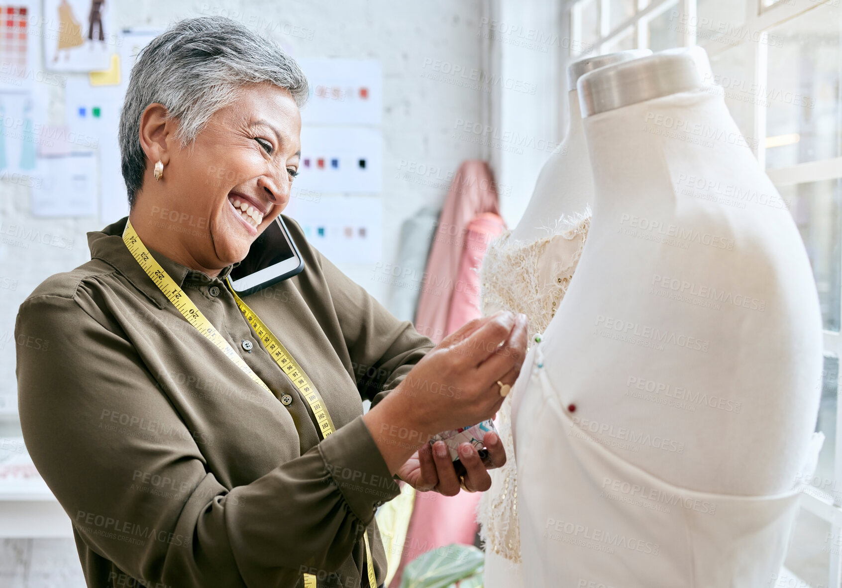 Buy stock photo Fashion, designer and phone call of woman with mannequin in workshop. Startup, smartphone and happy elderly female seamstress or tailor talking or networking with contact while sewing dress on dummy