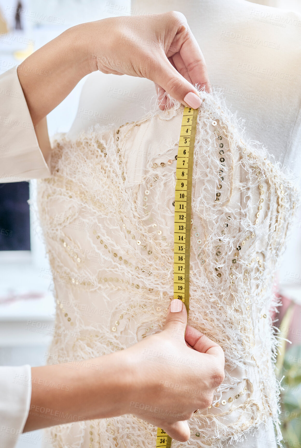 Buy stock photo Hands, fashion and measuring tape by woman designer for dress, pattern and details of fabric in studio. Creative, girl and measurement by dressmaker working on luxury, elegant and classic clothing