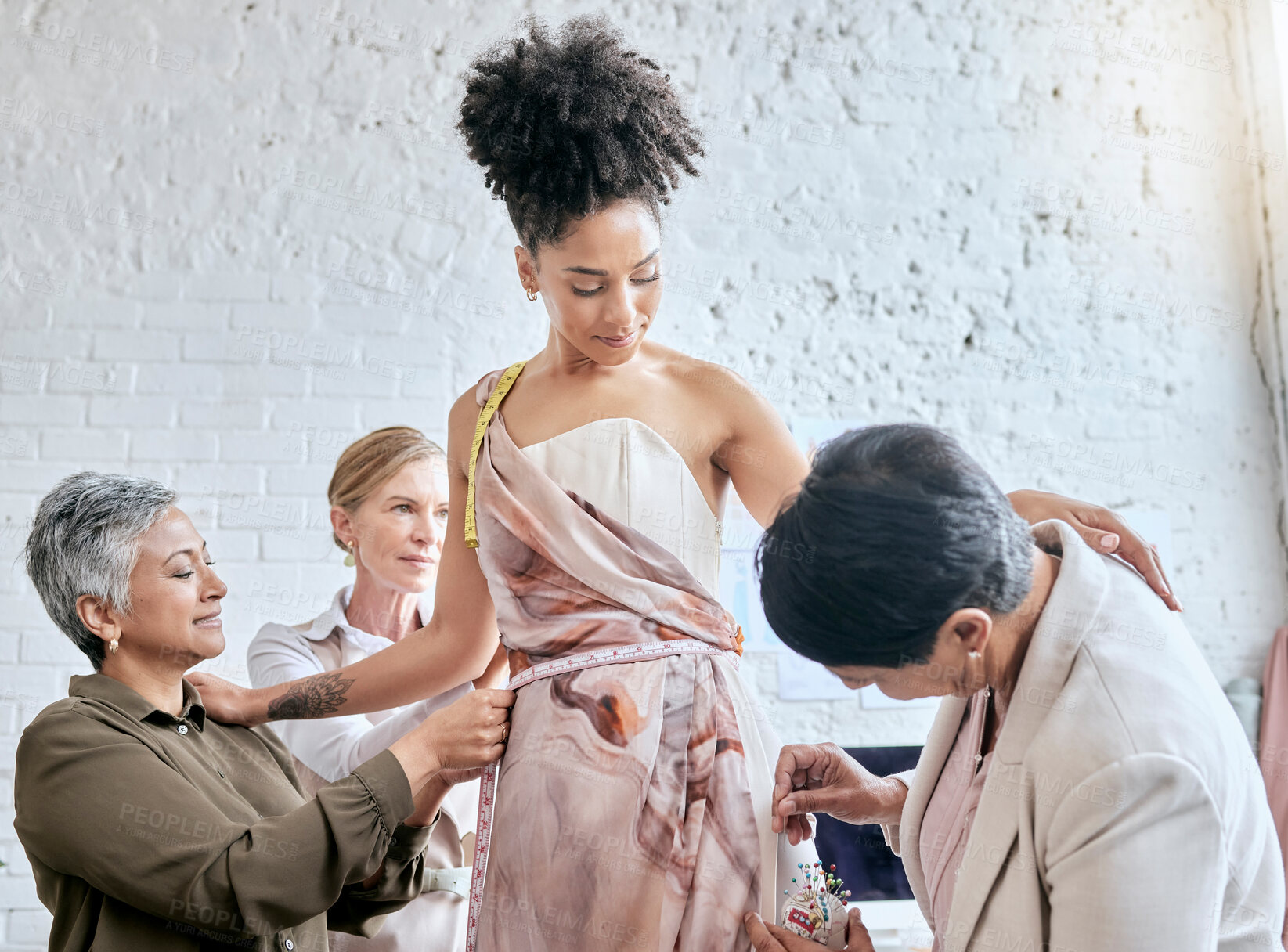 Buy stock photo Designer women, model and fitting dress for focus, design or teamwork for runway fashion in workshop. Happy team, woman collaboration and success vision for diversity, goals or helping hand in studio