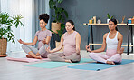 Pregnant, yoga or women in class for meditation, exercise or fitness workout in zen house studio. Pregnancy, peace or relaxed friends in maternity training in calm lotus pose for mindfulness at home