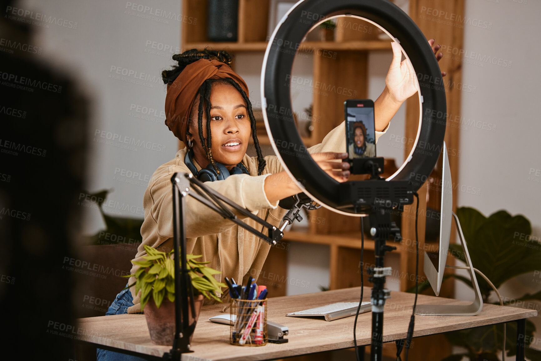 Buy stock photo Communication, phone and influencer live streaming podcast, radio talk show or speaker talk about teen culture. Presenter microphone, black woman setup broadcast or speaking about online student news