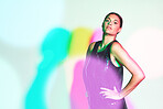 Woman, fashion portrait and neon shadow for a kaleidoscope party with color on a studio background. Beauty, art and aesthetic model confident about creative style for magazine mockup or copyspace