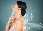 Beauty, water and skincare splash on woman cleaning skin for hygiene and hydration isolated in a studio background. Self care, grooming and female dermatology for young beautiful adult