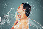 Studio, bathroom and skincare water splash on woman skin for hygiene and hydration isolated in background. Self care, dermatology and female washing to be a young beautiful adult or model