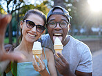 Love, ice cream or couple of friends take a selfie in a park on a romantic date in nature in an interracial marriage. Pictures, black man or happy woman eating or enjoying a snack on holiday vacation