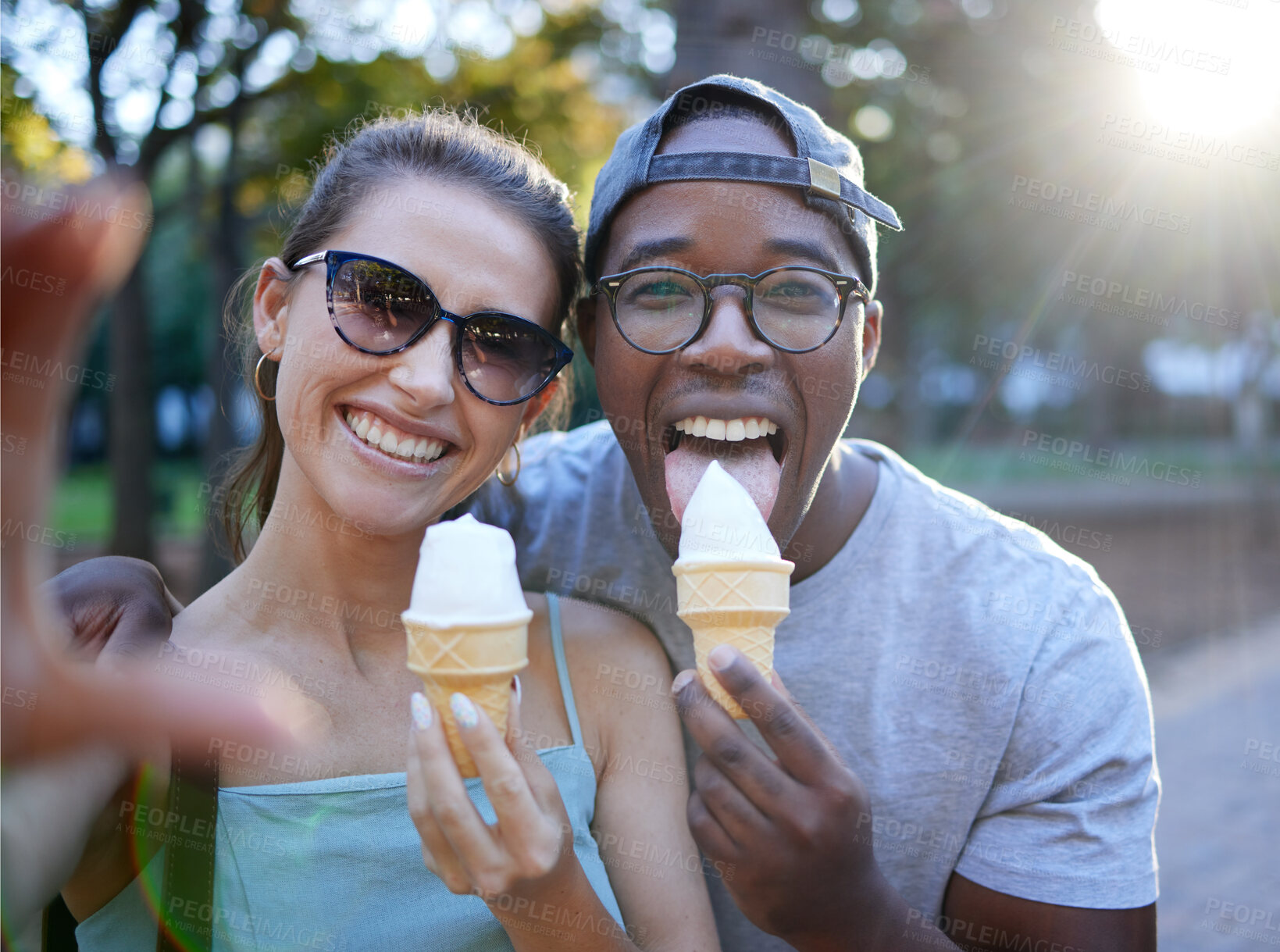 Buy stock photo Love, ice cream or couple take a selfie in a park on a romantic date in nature in an interracial marriage. Pictures, black man or happy woman eating or enjoying a snack on holiday vacation